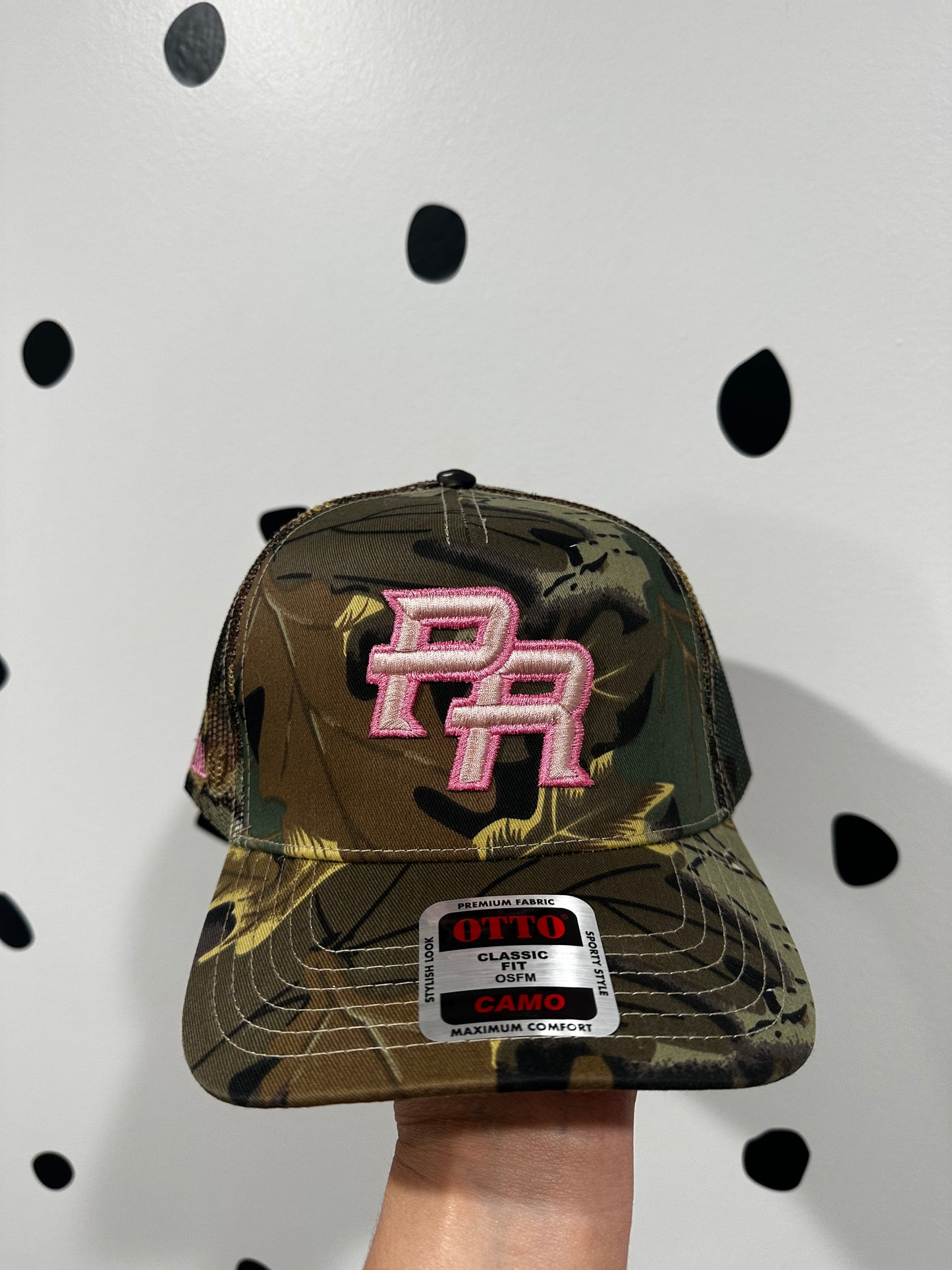 PR (Puerto Rico) embroidered 3D in pink thread on a Otto camo trucker hat.