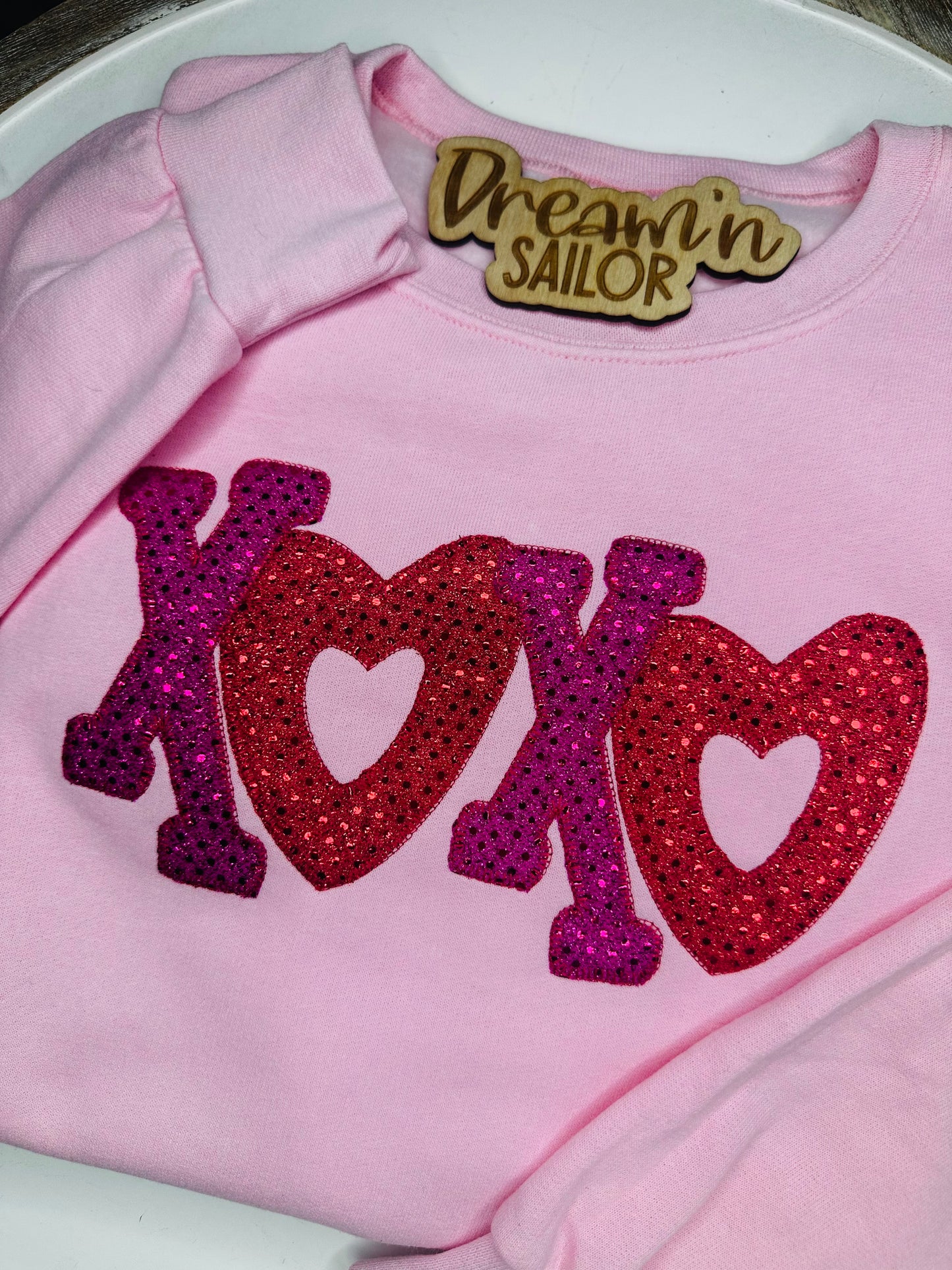 XOXO embroidered appliqué with fabric.