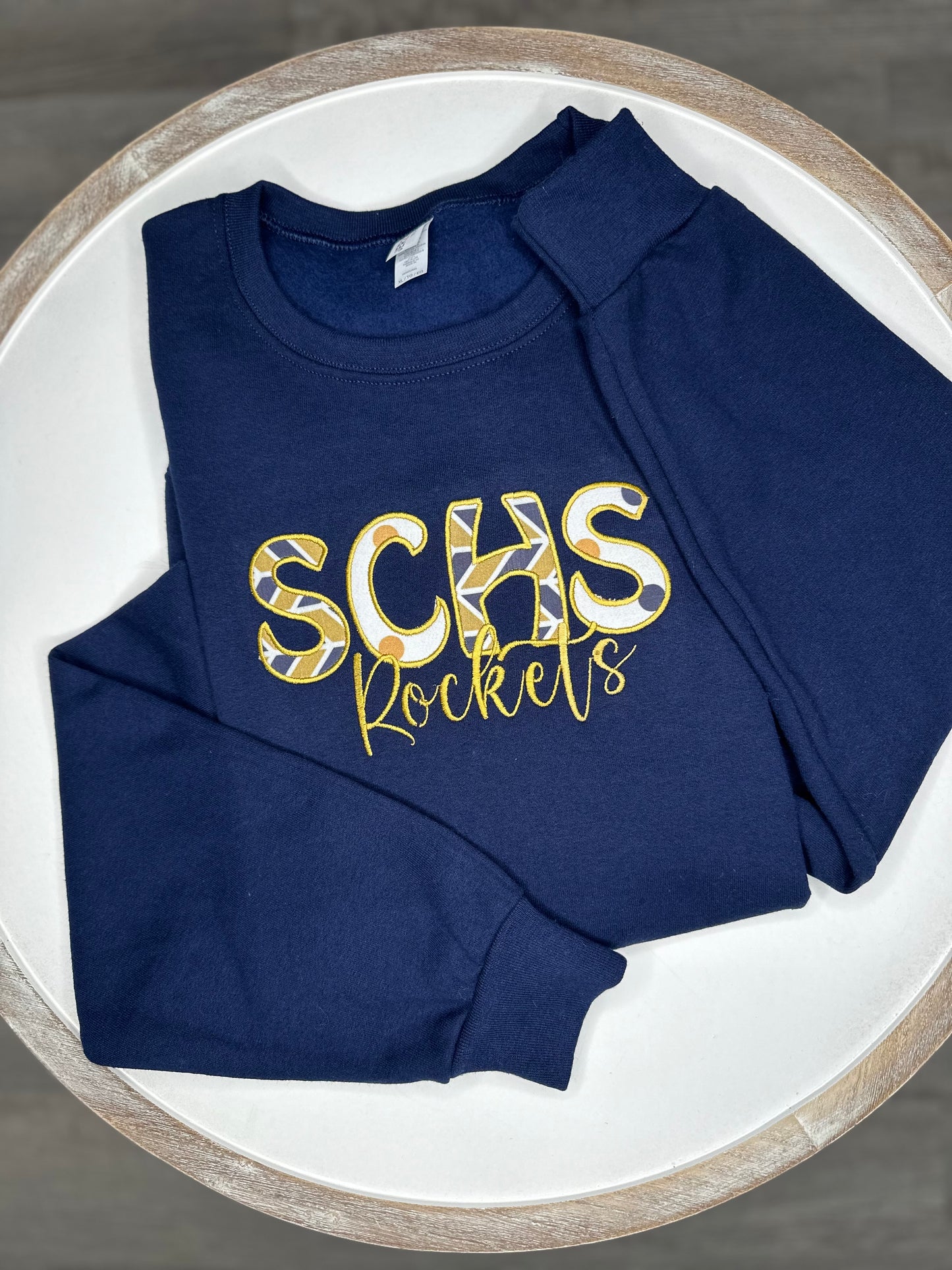 Custom school spirit appliqué crewneck sweater.