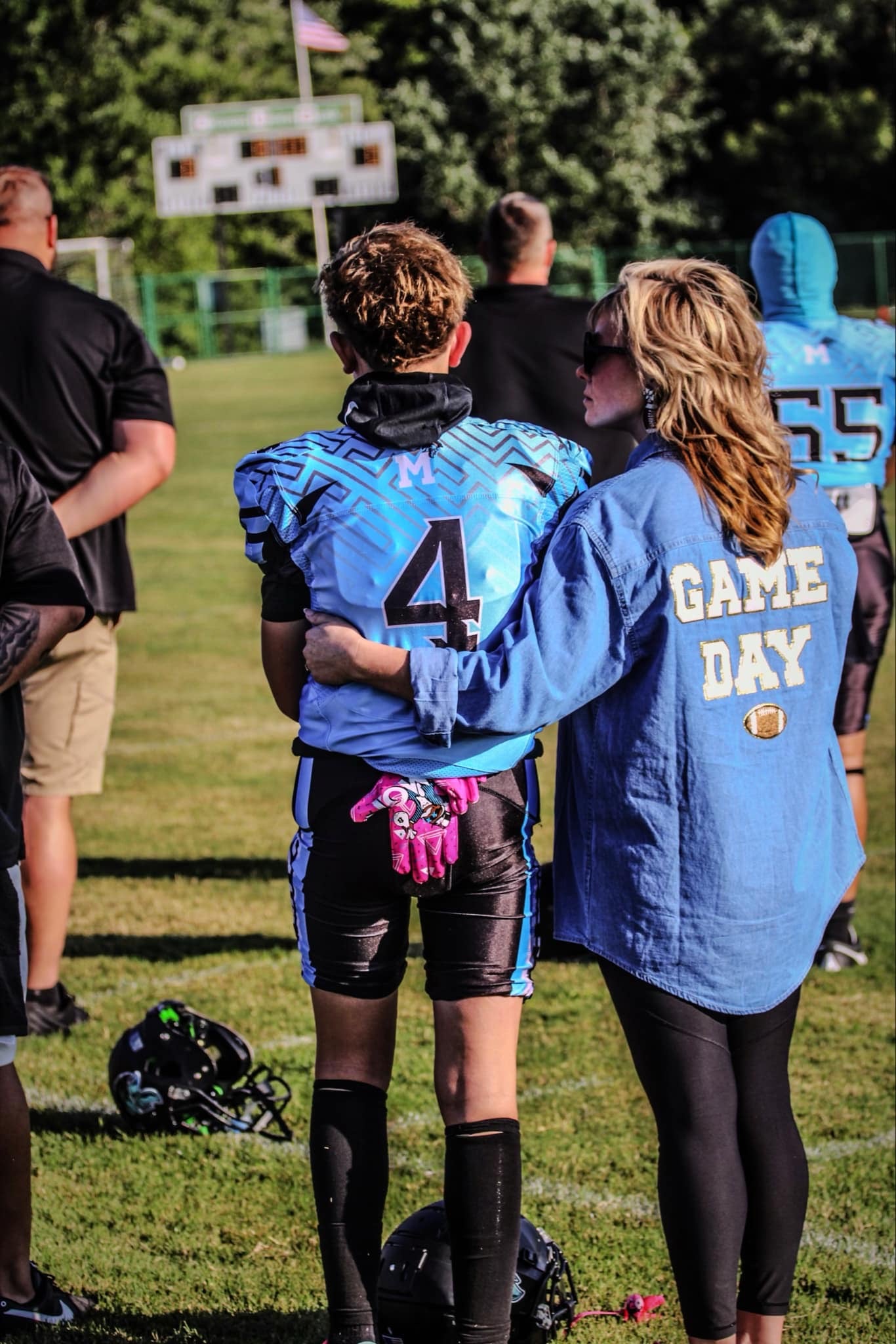 Custom mom crewneck sweatshirt with picture embroidered as the “o” and M’s in football font.