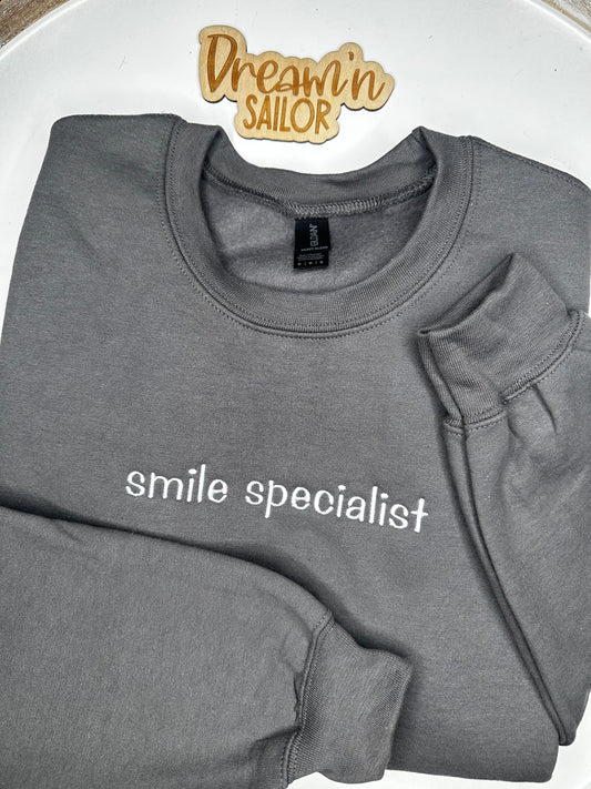 Smile Specialist embroidered on crewneck sweatshirt