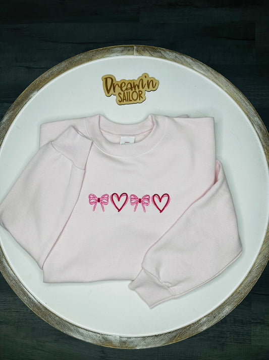 Bows and hearts embroidered on crewneck sweatshirt