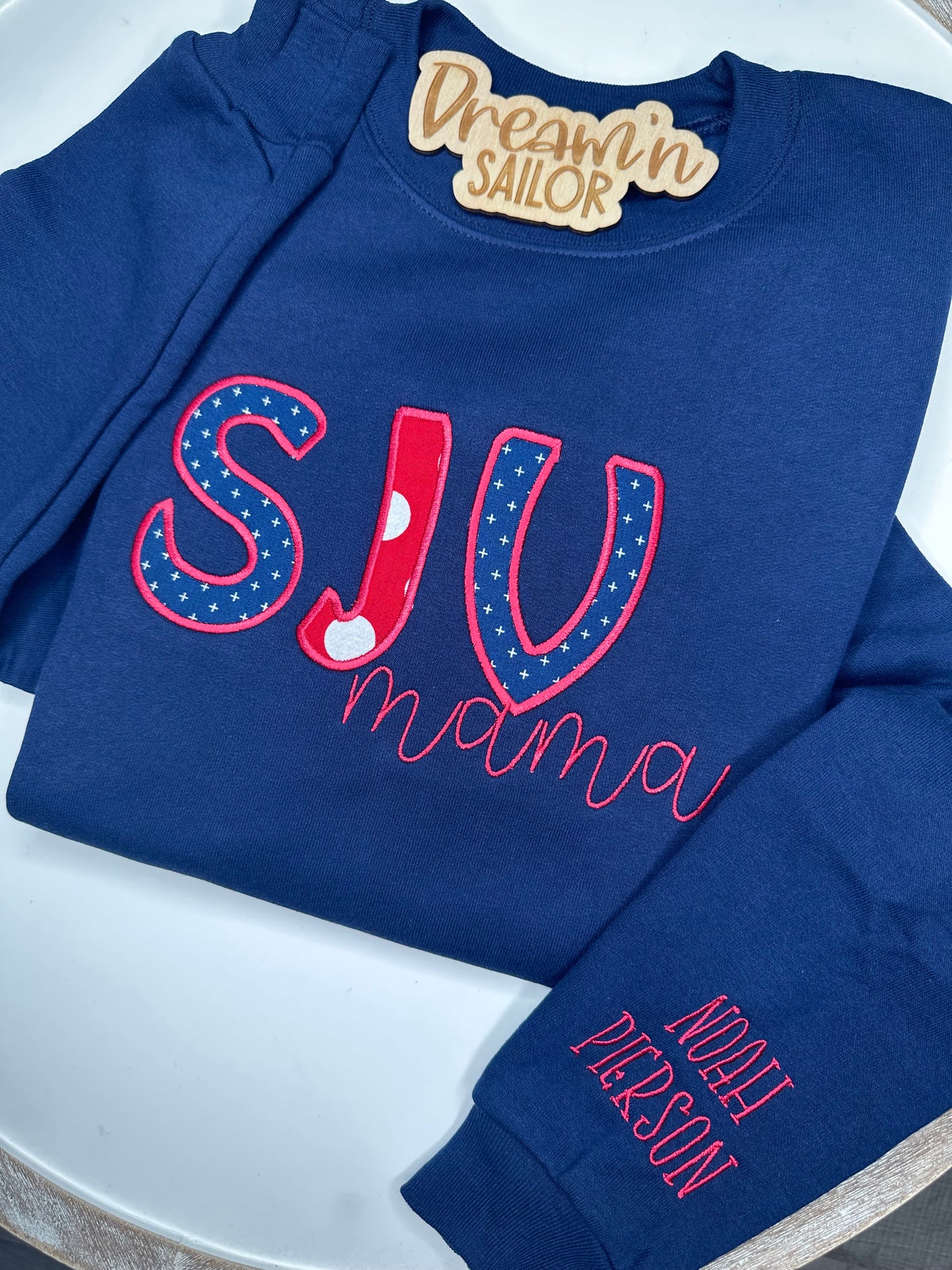 Custom school spirit appliqué crewneck sweater.